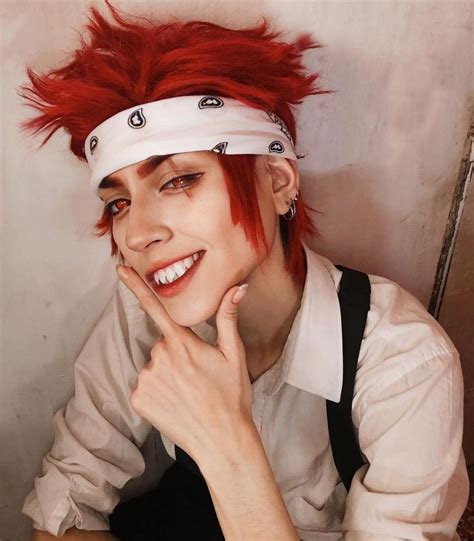 a woman with red hair wearing a white headband