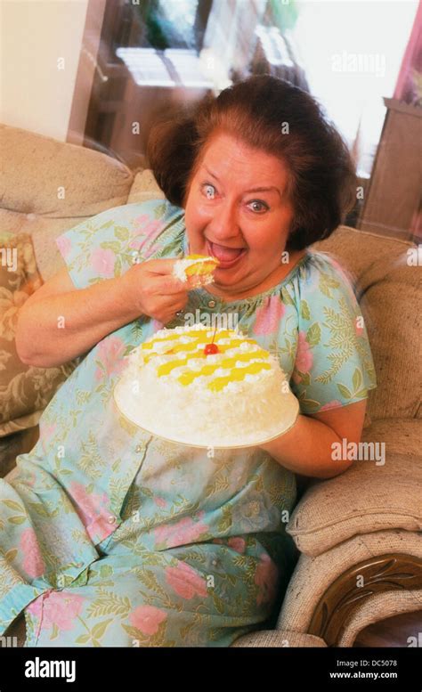 Fat woman eating cake Stock Photo - Alamy