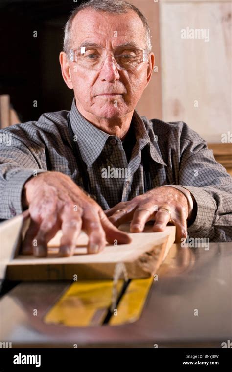 Senior man in woodworking shop using table saw Stock Photo - Alamy