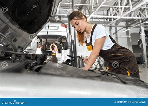 Female Mechanic in White Shirt and Coverall Repairing Engine Stock Image - Image of checking ...