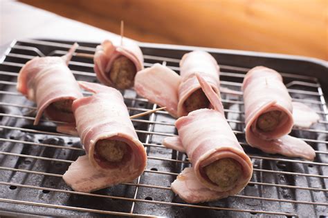 Free Stock Photo 17182 Preparing pigs in blankets on a wire rack | freeimageslive
