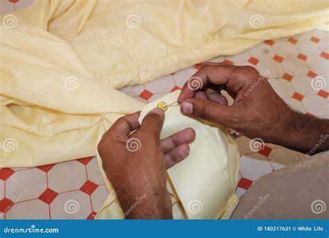 Sewing buttons of shirt stock image. Image of april - 180217631