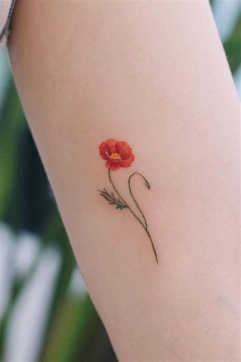 a single flower tattoo on the left arm