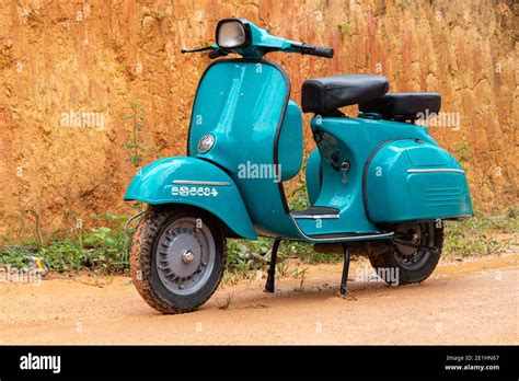 Old vintage blue colored scooter bike on a muddy road, front view Stock Photo - Alamy