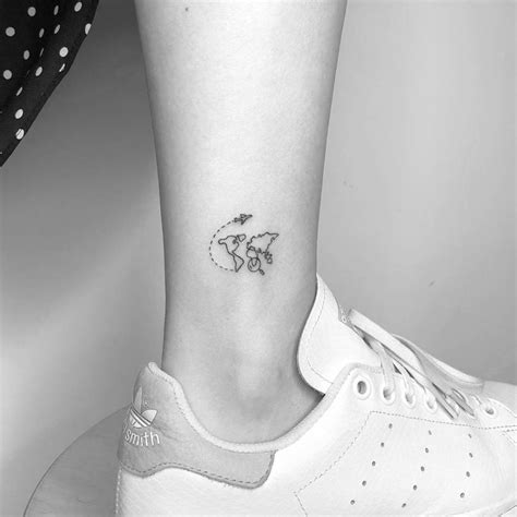 Small world map tattoo on the ankle.