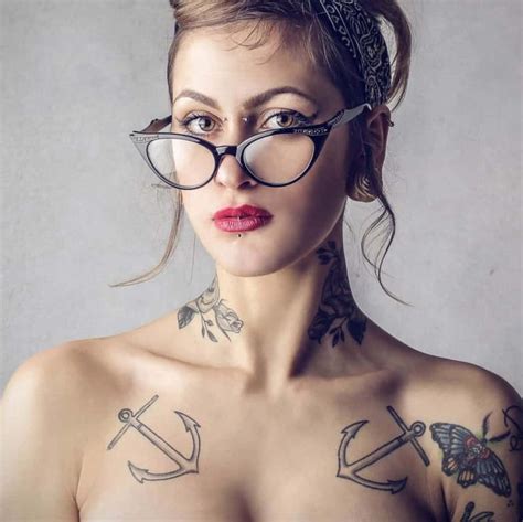 a woman with glasses and tattoos on her chest