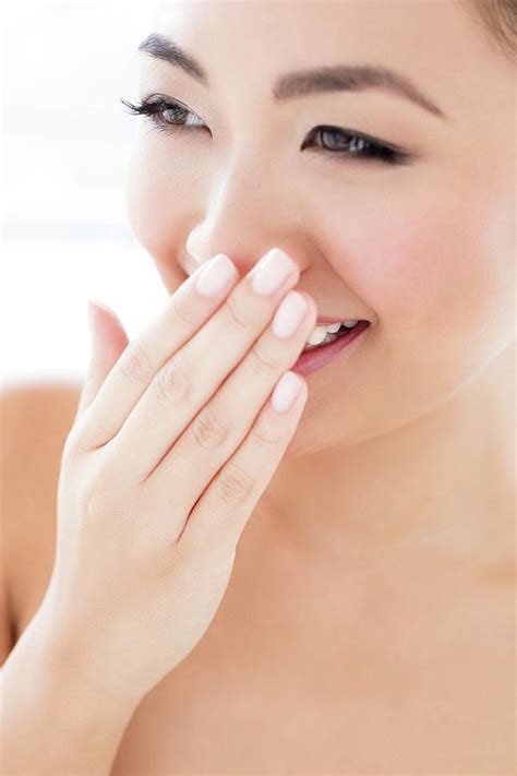 Woman Laughing With Hand Covering Mouth Photograph by Ian Hooton ...