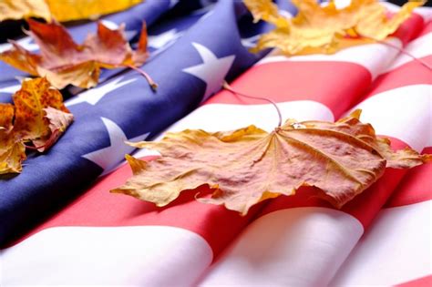Premium Photo | Flag united states of america is strewn with yellowed autumn maple leaves
