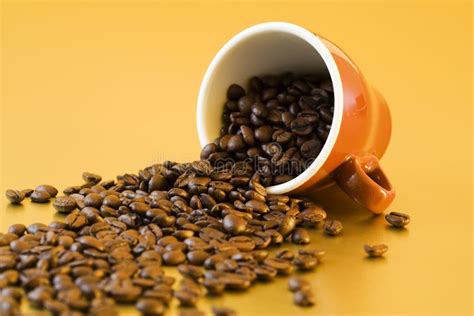 Coffee Beans Falling from Mug Stock Photo - Image of tilted, brown: 7142348