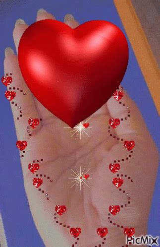 a hand holding a red heart with lots of small hearts on it's palm