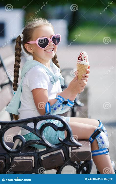 Cheerful Little Girl In The Park With Ice Cream Cone Stock Image - Image of face, bench: 74748285