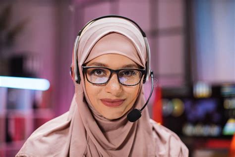Smiling Positive Confident Woman in Hijab and Headset Sitting at Office ...