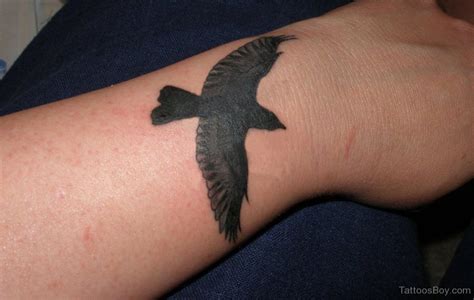 Black Bird Tattoo On Wrist | Tattoo Designs, Tattoo Pictures