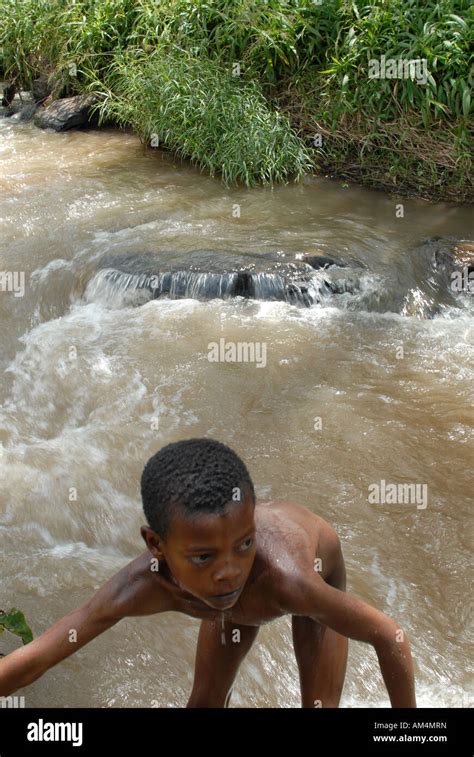 An Ethiopian boy climbs out of the river he has been swimming in Stock ...