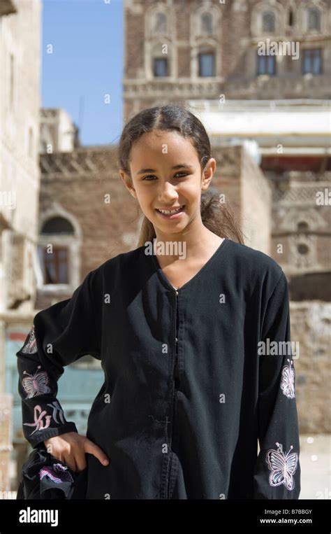 Young Yemeni girl posing in the old town district of Sana a Yemen Stock ...