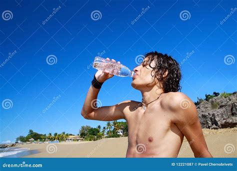 Man is Drinking Water from Bottle on Beach Stock Image - Image of ...