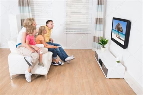 Young Family Watching TV Together — Stock Photo © AndreyPopov #55360421