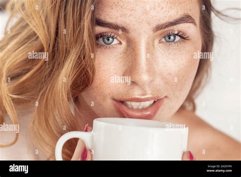 Beauty portrait od delicate caucasian lady with white coffee cup. Beautiful ginger woman with ...