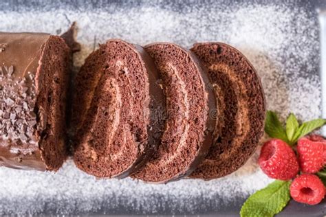 Chocolate Swiss Roll with Jam Decorated with Raspberries on a Plate. Selective Focus Stock Photo ...