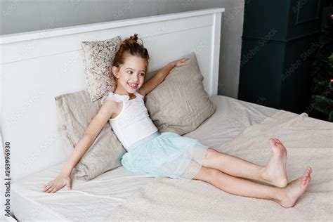 little cute girl is lying on the bed Stock Photo | Adobe Stock