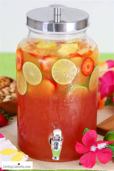 a pitcher filled with fruit and lemons on top of a table