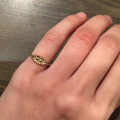 Gold ring with eye shape and rhinestone in middle... - Depop