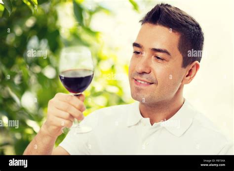happy man drinking red wine from glass Stock Photo - Alamy