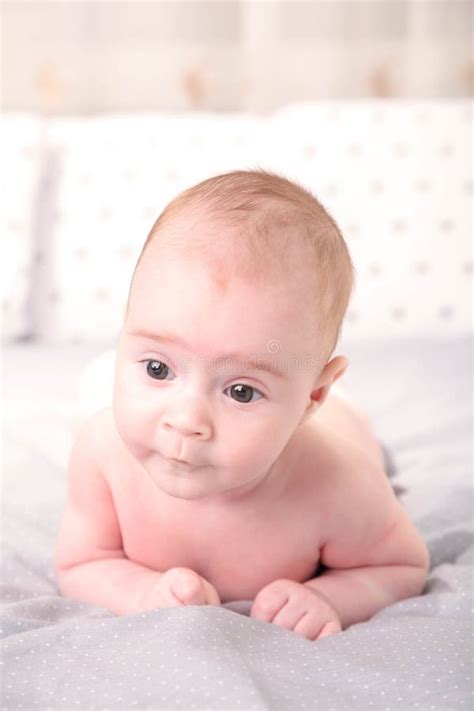 Happy Young Baby Lying on Tummy on a White Background Stock Photo - Image of girl, laying: 183935428