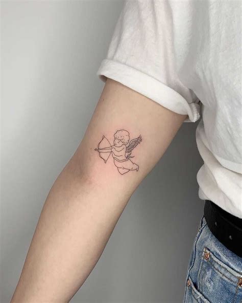 Outline Cupid tattoo inked on the right arm by Conz Thomas | Cupid ...