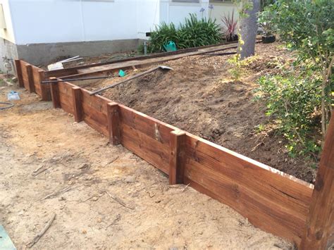 DIY timber retaining wall in the making. Treated pine lengths with a ...