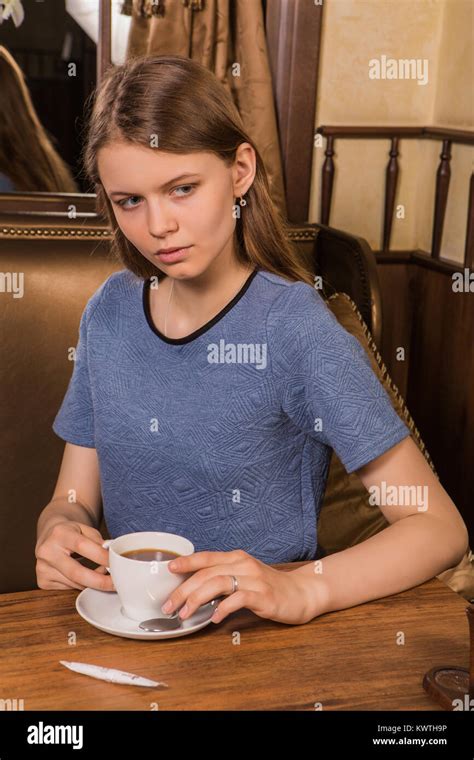 Portrait of young female student in modern coffee shop with coffee cup Stock Photo - Alamy