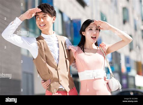 Stylish young Chinese couple looking at view Stock Photo - Alamy