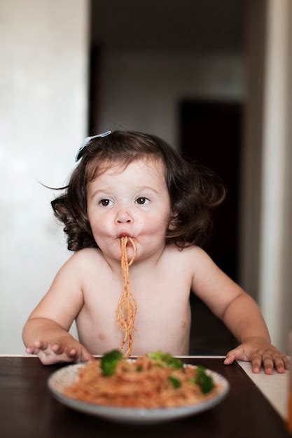 Free Photo | Funny baby girl eating spaghetti