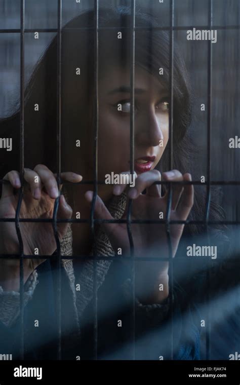 Woman behind bars hi-res stock photography and images - Alamy