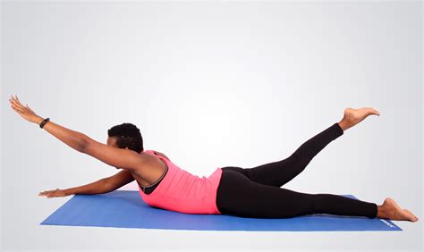 Fit woman doing swimmers core exercise