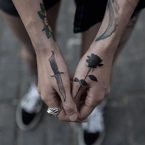 black work rose and knife tattoo on hands by Joice Wang #SwordsofAllMakes | Black rose tattoos ...