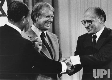 Photo: Carter, Sadat, and Begin shake hands at Camp David peace treaty ...