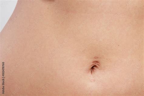 woman belly with piercing scar in the navel Stock Photo | Adobe Stock