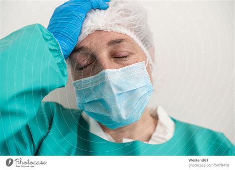 Portrait of exhausted woman wearing personal protective equipment - a Royalty Free Stock Photo ...