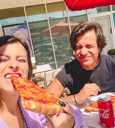 A imagem pode conter: 2 pessoas, pessoas comendo, pizza e comida ...