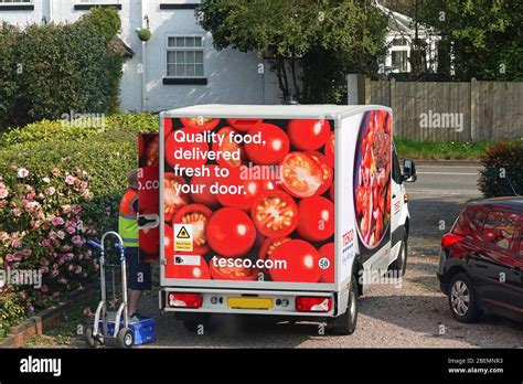 A Tesco delivery driver and van delivering groceries to a household Stock Photo - Alamy