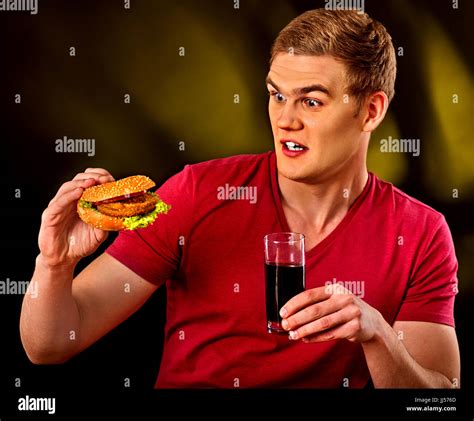 Man eating french fries and hamburger Stock Photo - Alamy