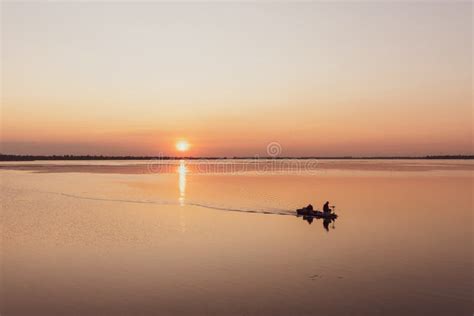 Silhouette of a Fishing Boat on the Lake in Sunset Sky Stock Photo ...