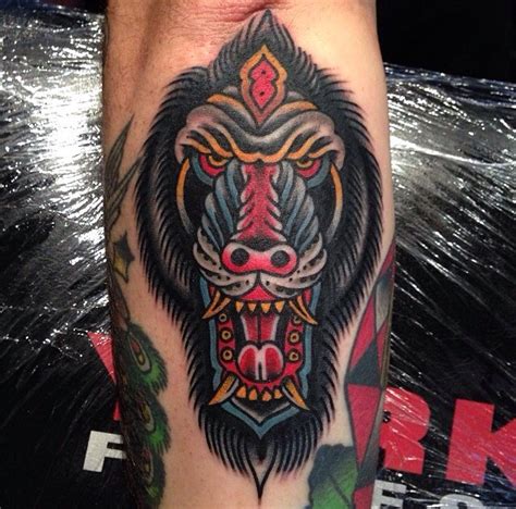 Frightened colorful baboon head tattoo on arm - Tattooimages.biz