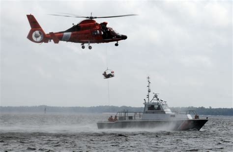 A Coast Guard MH-65 Dolphin crew rescue a swimmer near Dauphin Island