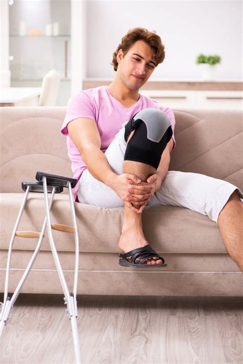 The Young Man with Injured Knee Recovering at Home Stock Image - Image of physical, pain: 138477015