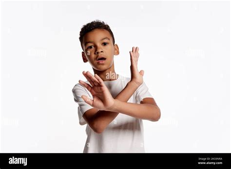 Portrait of scared african little boy in white tee expressing emotions isolated over white ...