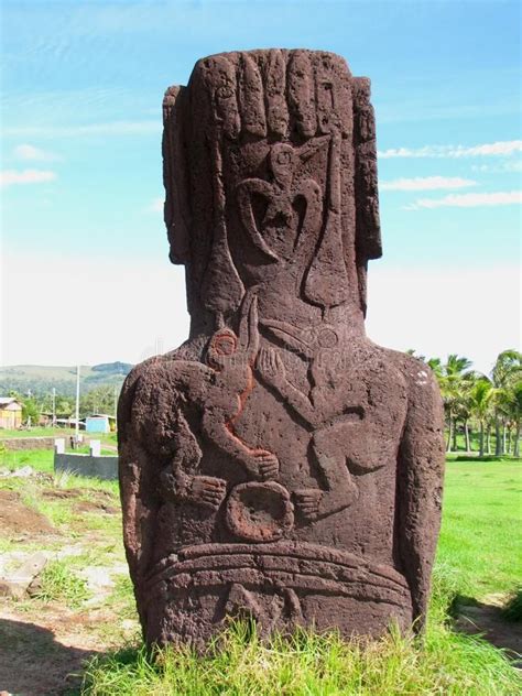 an ancient statue in the grass on a sunny day