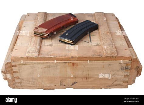 m16 and ak47 magazins on wooden army ammo box isolated on white ...