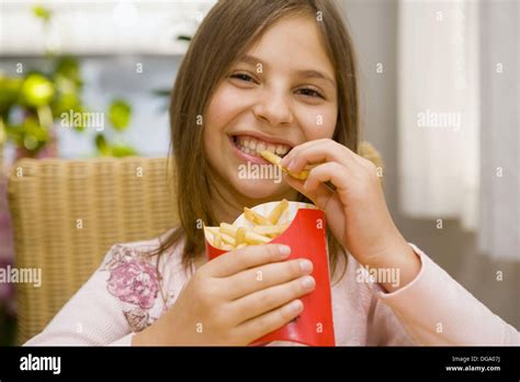 Girl eating french fries Stock Photo - Alamy